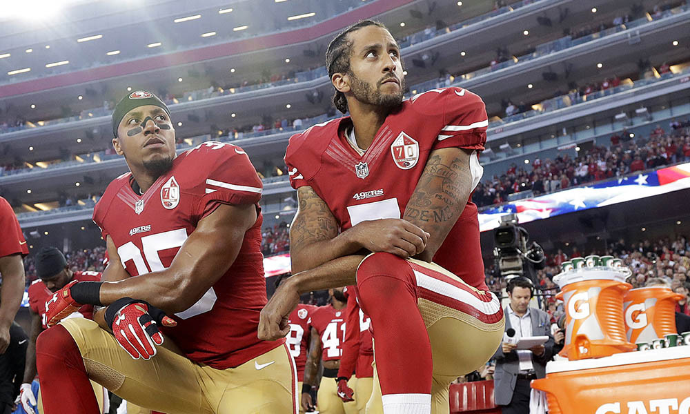 FILE - Int his Monday, Sept. 12, 2016, file photo, San Francisco 49ers safety Eric Reid (35) and quarterback Colin Kaepernick (7) kneel during the national anthem before an NFL football game against the Los Angeles Rams in Santa Clara, Calif. Reid has resumed his kneeling protest for human rights during the national anthem, after joining then-teammate Kaepernick's polarizing demonstration last season. (AP Photo/Marcio Jose Sanchez, File) ORG XMIT: NYHK702